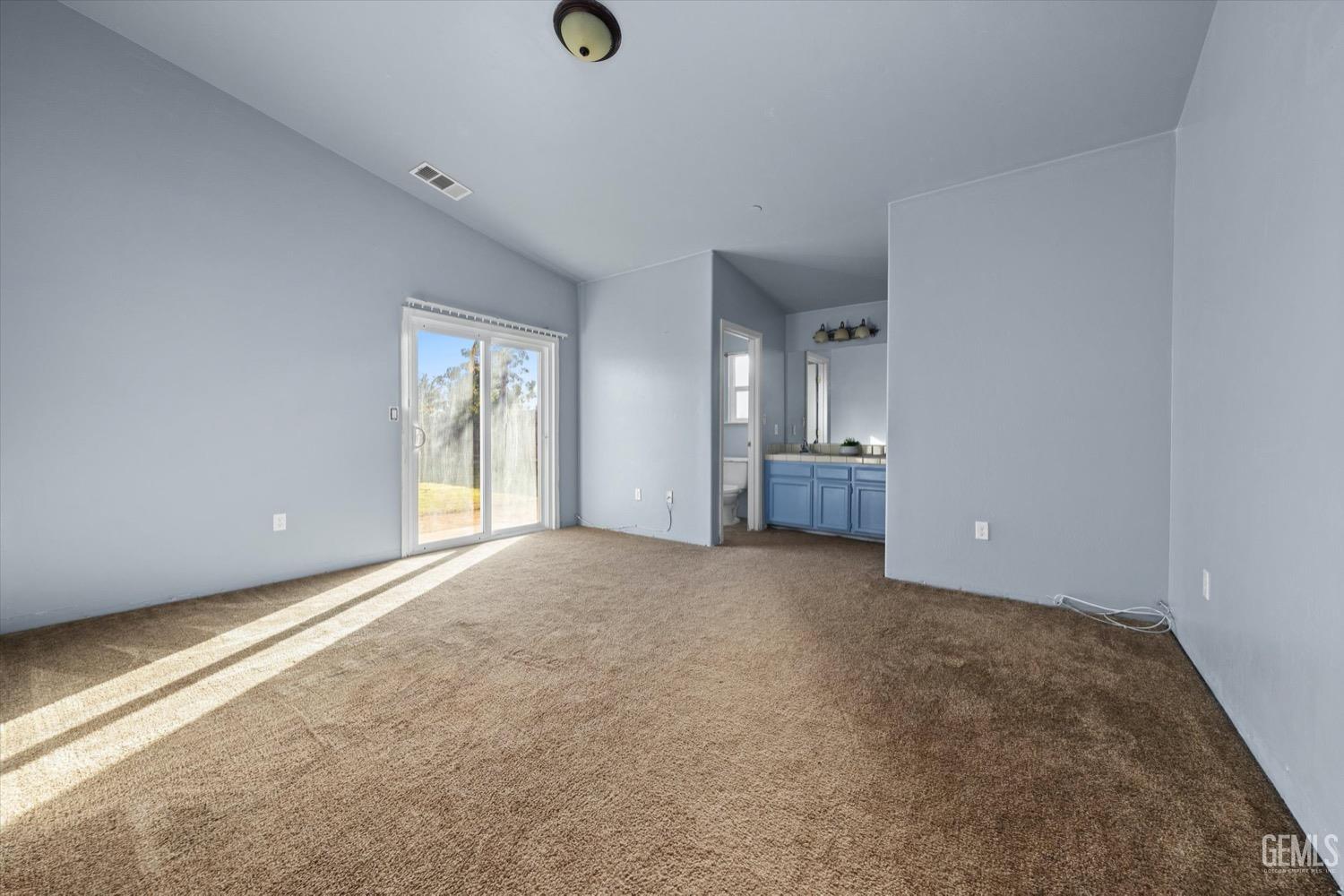 Undisclosed Address Shafter, CA 93263 - Photo 17 of 30 an empty room with a fireplace and windows