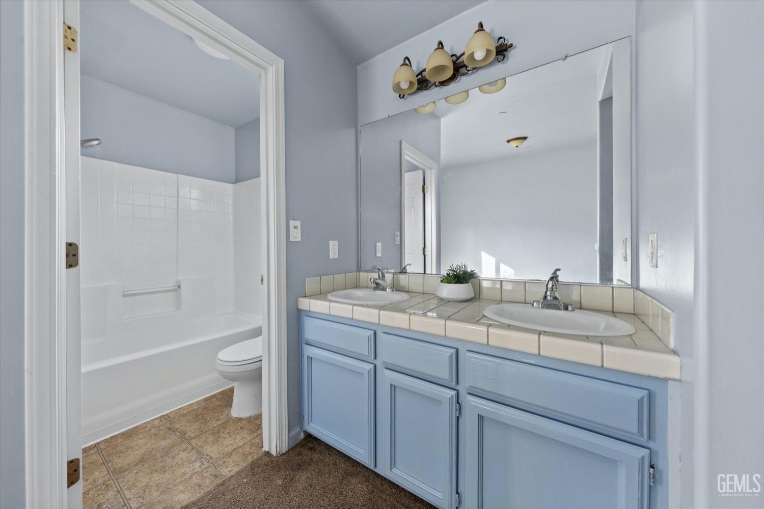 Undisclosed Address Shafter, CA 93263 - Photo 19 of 30 a bathroom with a granite countertop sink a toilet and shower
