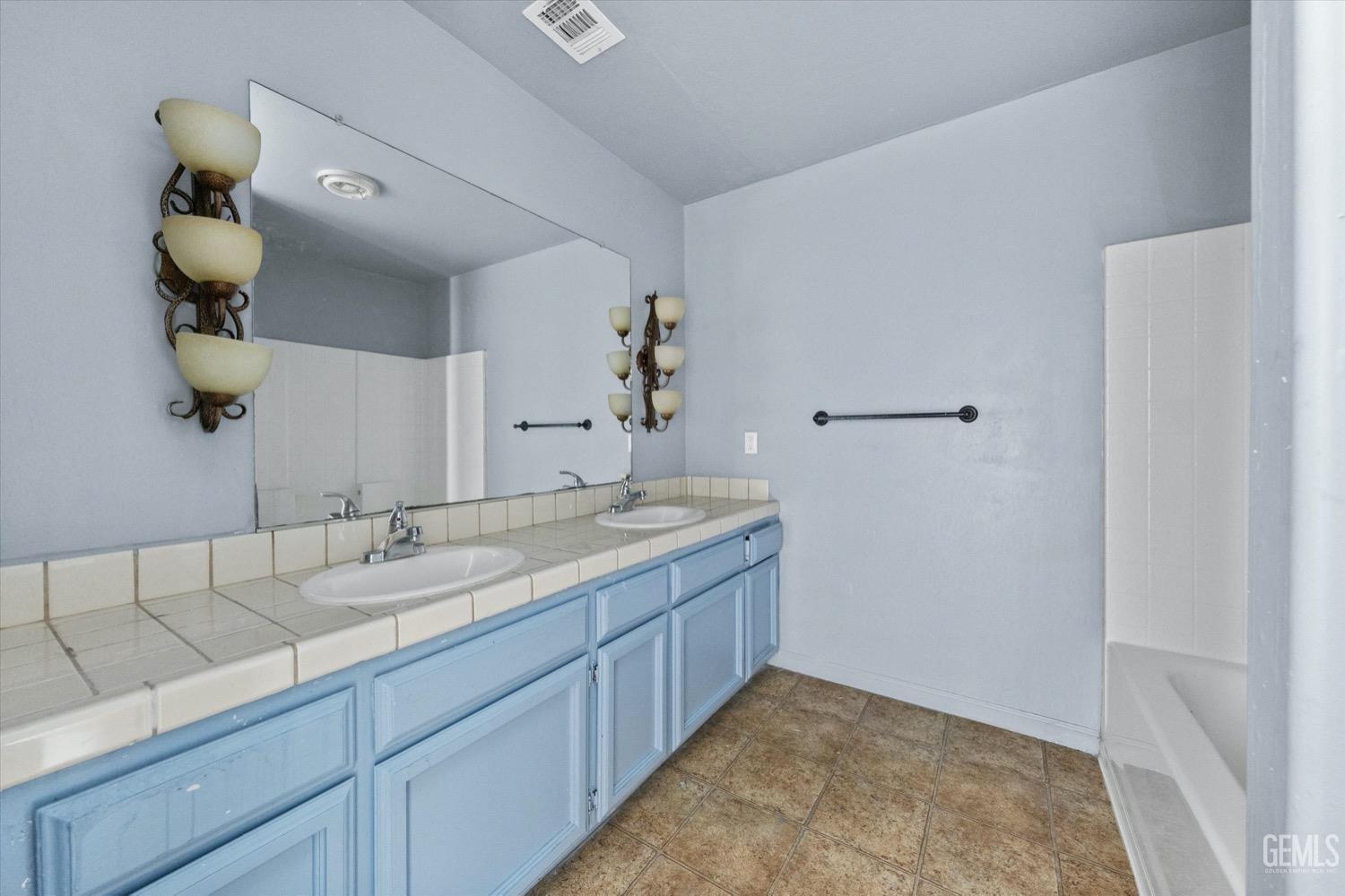 Undisclosed Address Shafter, CA 93263 - Photo 23 of 30 a bathroom with a granite countertop sink and a mirror