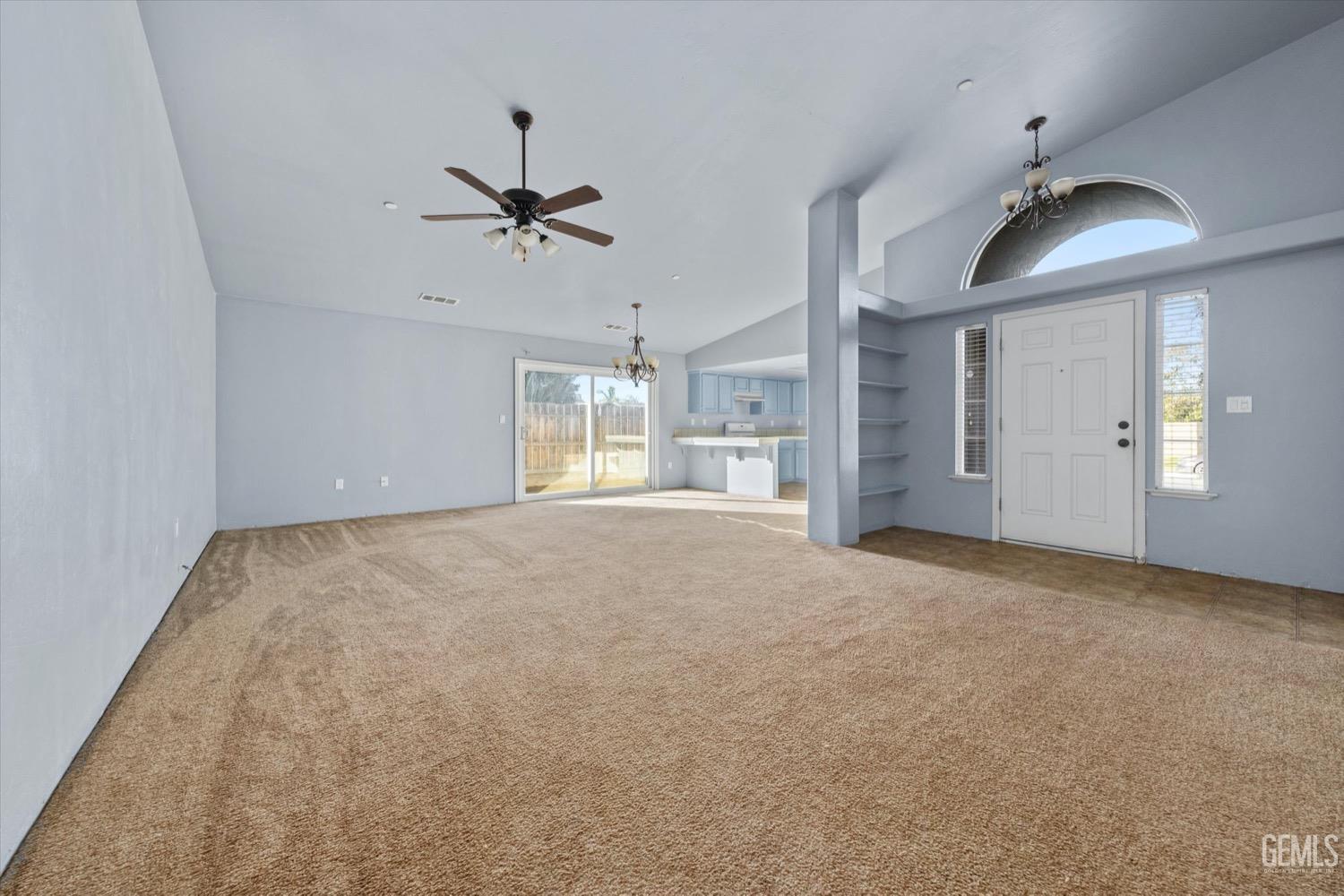 Undisclosed Address Shafter, CA 93263 - Photo 8 of 30 an empty room with chandelier fan and windows