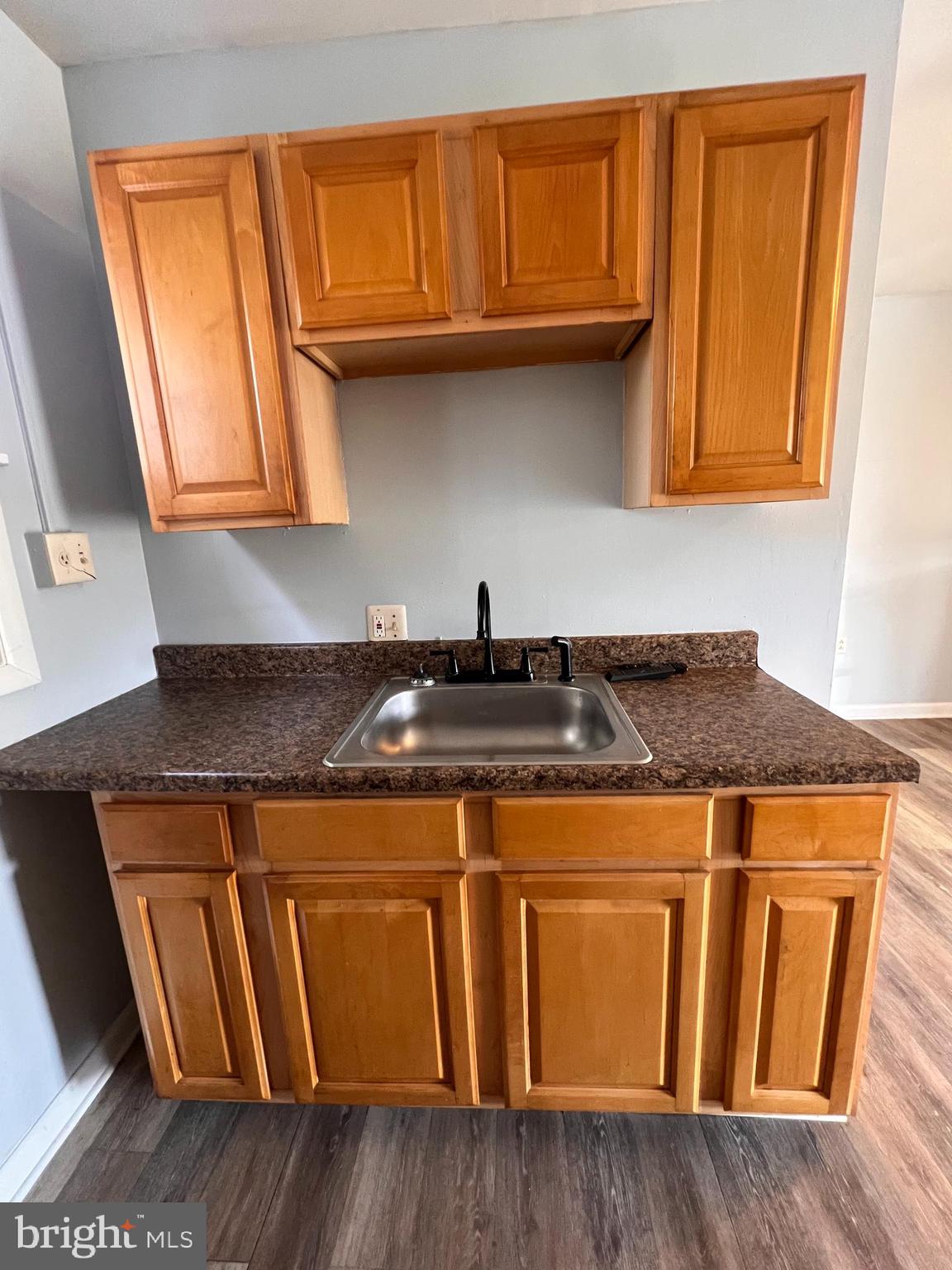349 Halltown Road, Unit 8 Harpers Ferry, WV 25425 - Photo 4 of 7 a kitchen with granite countertop wooden cabinets and a granite counter top