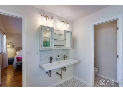 a bathroom with a tub shower and sink