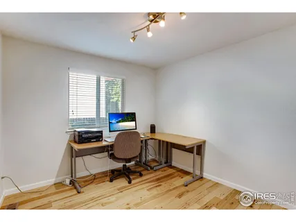 a view of an empty room and wooden floor