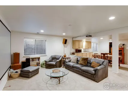 a living room with furniture a large window and a flat screen tv
