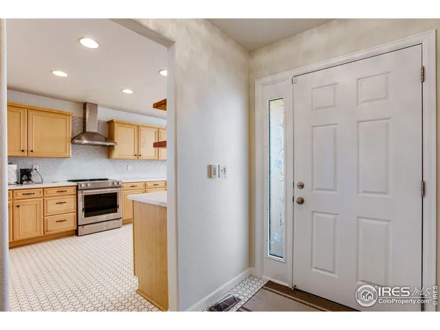 a kitchen with granite countertop white cabinets and stainless steel appliances