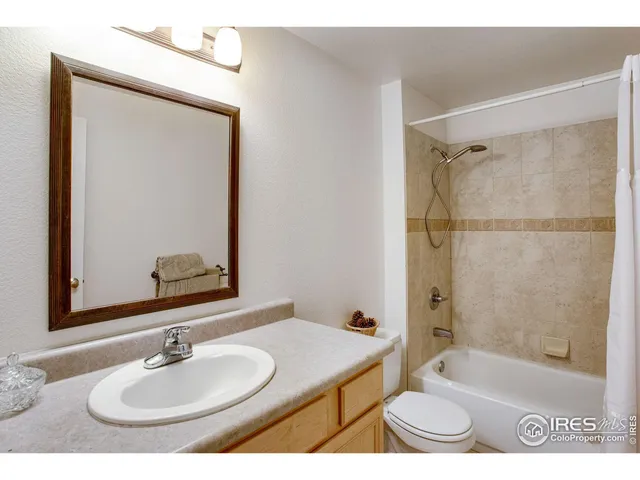 a bedroom with a bed and a book shelf