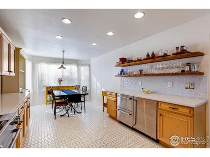 a open kitchen with sink and wooden floor