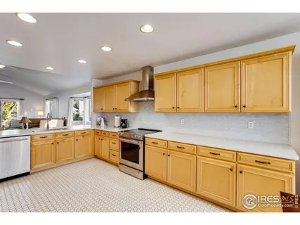 a kitchen with cabinets oven and a sink