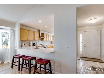 a kitchen with sink and chairs