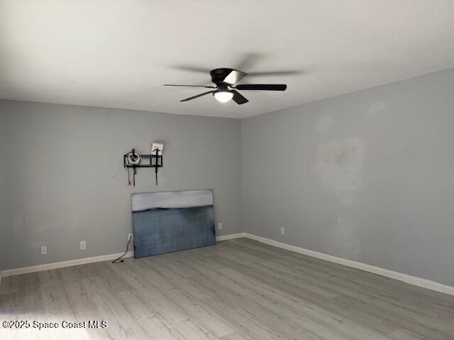 4517 Kaileen Circle Northeast Palm Bay, FL 32905 - Photo 16 of 34 wooden floor in an empty room with a chandelier fan