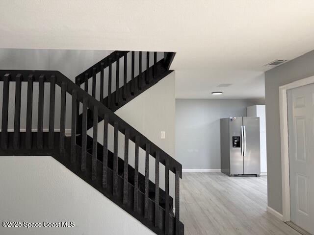 4517 Kaileen Circle Northeast Palm Bay, FL 32905 - Photo 18 of 34 a view of a hallway with wooden floor and stairs