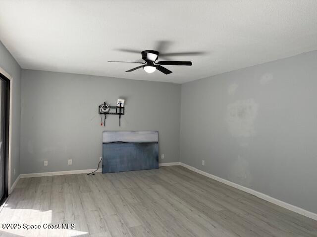 4517 Kaileen Circle Northeast Palm Bay, FL 32905 - Photo 19 of 34 a view of a ceiling fan with wooden floor and a chandelier fan