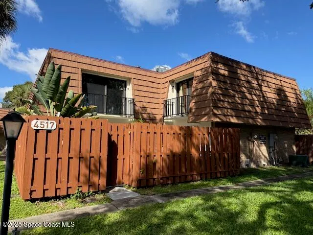 a view of a house with a small yard