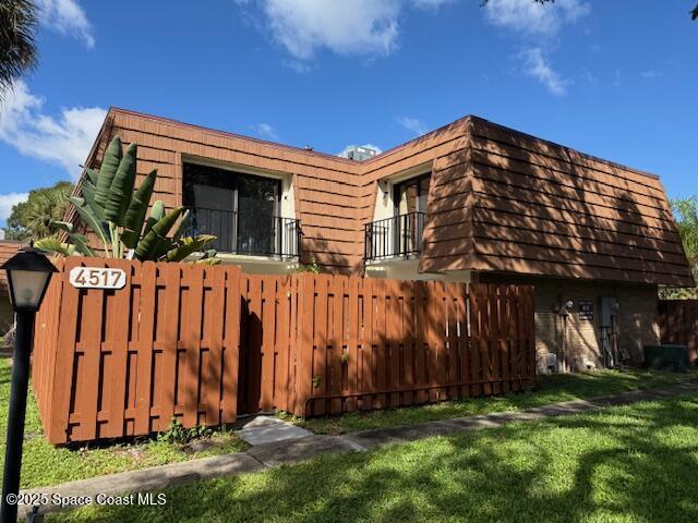 4517 Kaileen Circle Northeast Palm Bay, FL 32905 - Photo 2 of 34 a view of a house with a small yard