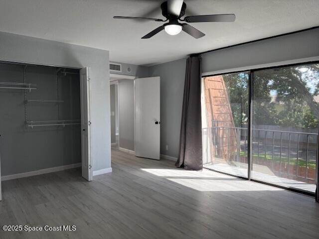 4517 Kaileen Circle Northeast Palm Bay, FL 32905 - Photo 21 of 34 an empty room with wooden floor and windows