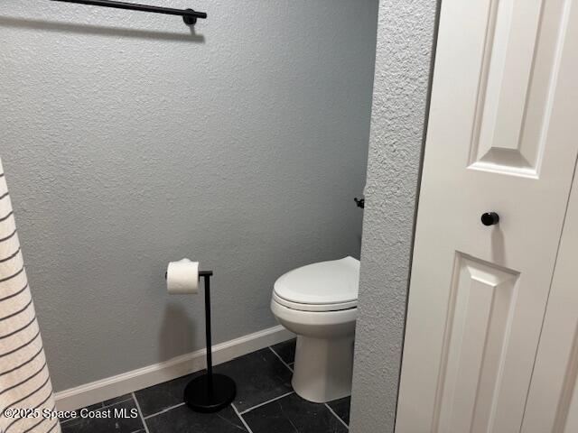 4517 Kaileen Circle Northeast Palm Bay, FL 32905 - Photo 27 of 34 a white toilet sitting next to a white sink