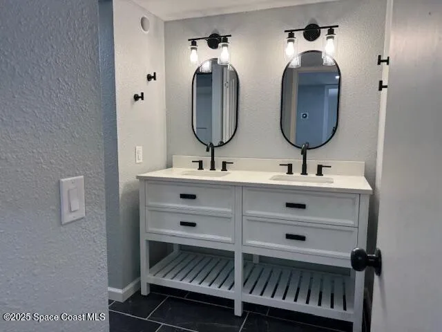 a bathroom with a double vanity sink and a mirror