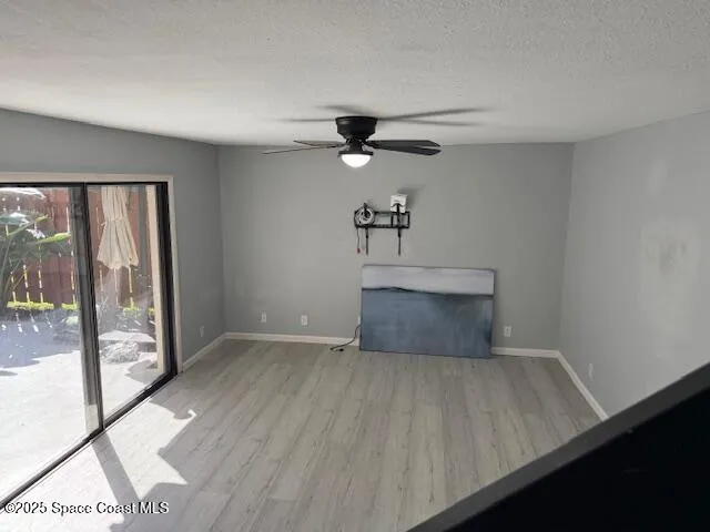 a view of a livingroom with a ceiling fan and window