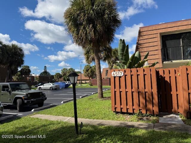 4517 Kaileen Circle Northeast Palm Bay, FL 32905 - Photo 34 of 34 a view of a backyard with potted plants and a large tree