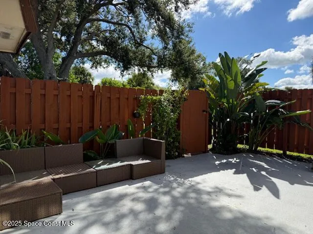 a backyard of a house with barbeque oven and outdoor seating