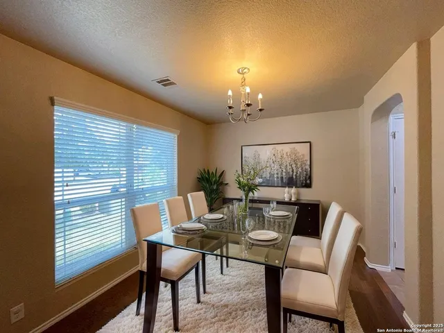 a view of a dining room with furniture and window
