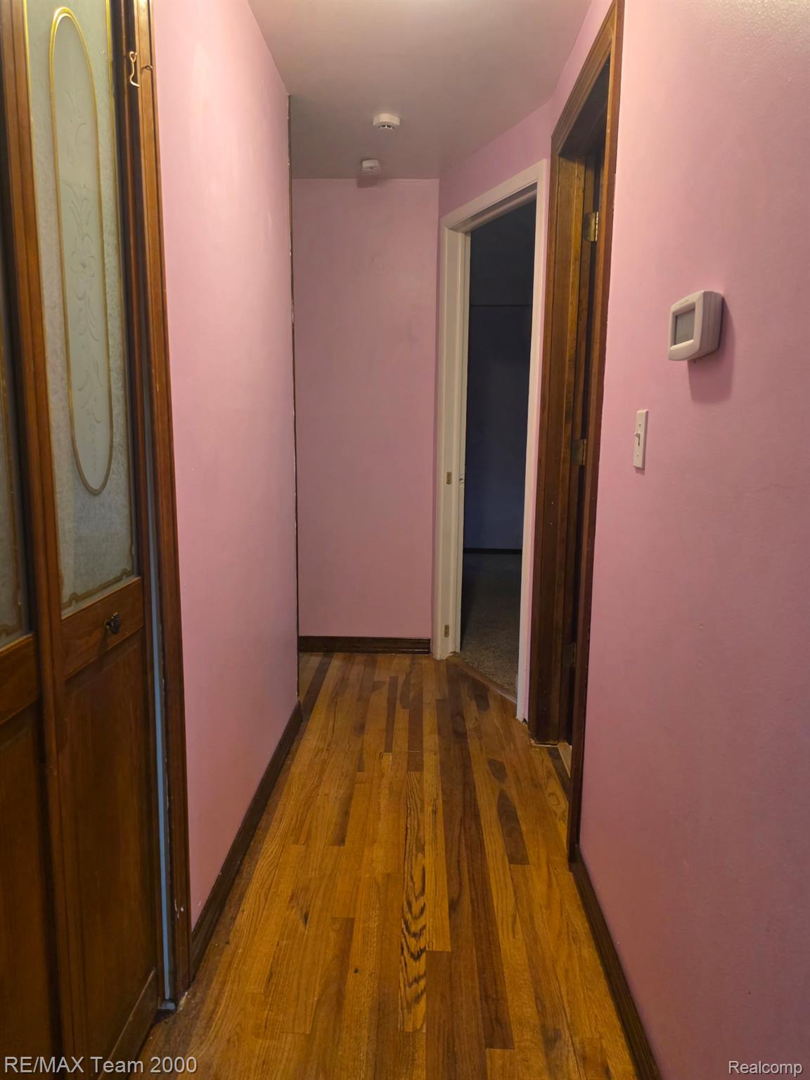 38114 Walnut Street Romulus, MI 48174 - Photo 6 of 18 Hallway featuring wood-finish flooring and solid core doors