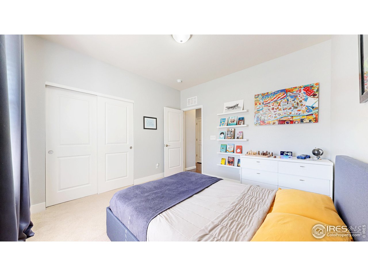 6794 Spring Rain Road Timnath, CO 80547 - Photo 18 of 49 a bedroom with a bed and a painting on the wall