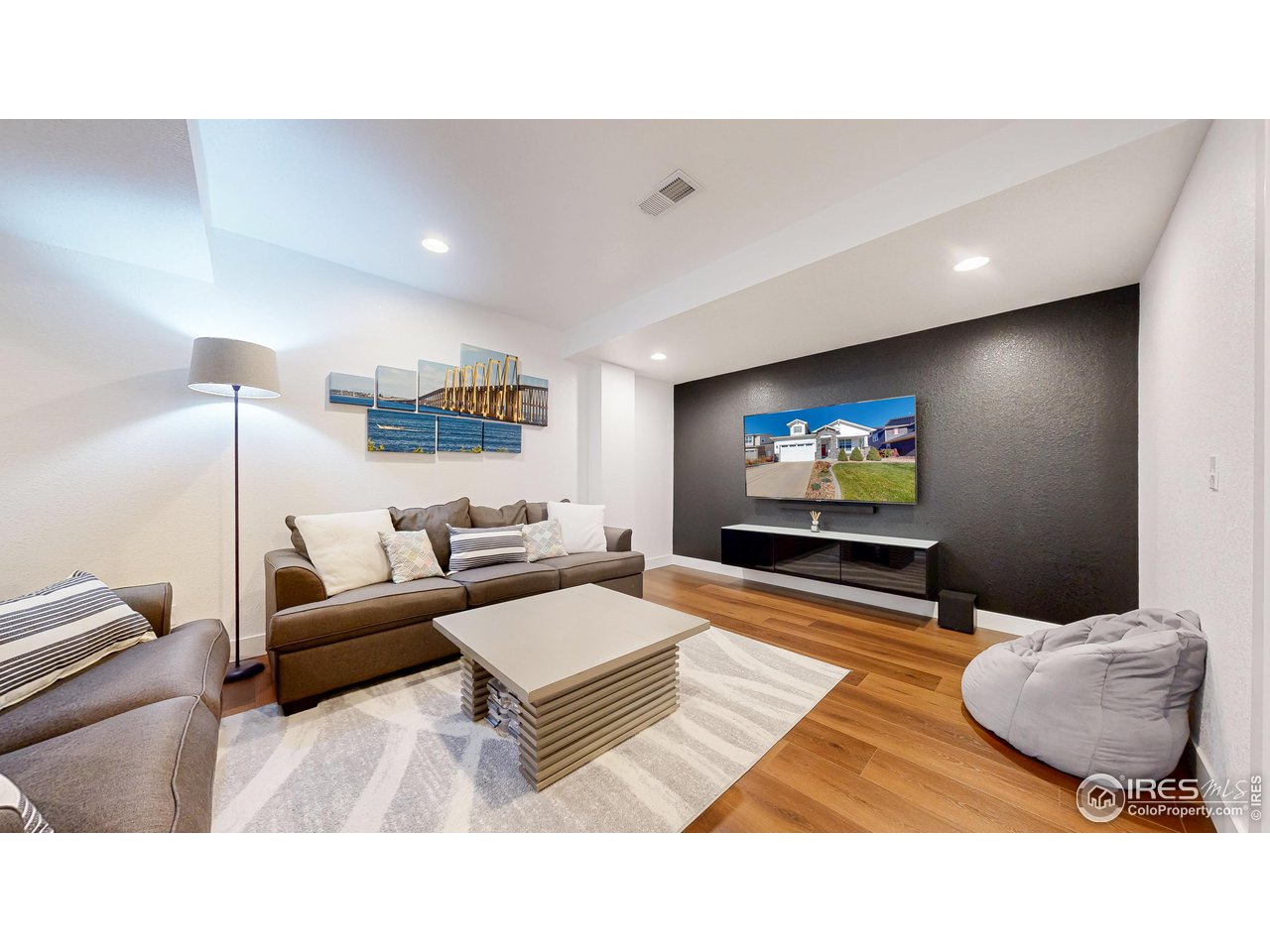6794 Spring Rain Road Timnath, CO 80547 - Photo 27 of 49 a living room with furniture and a flat screen tv
