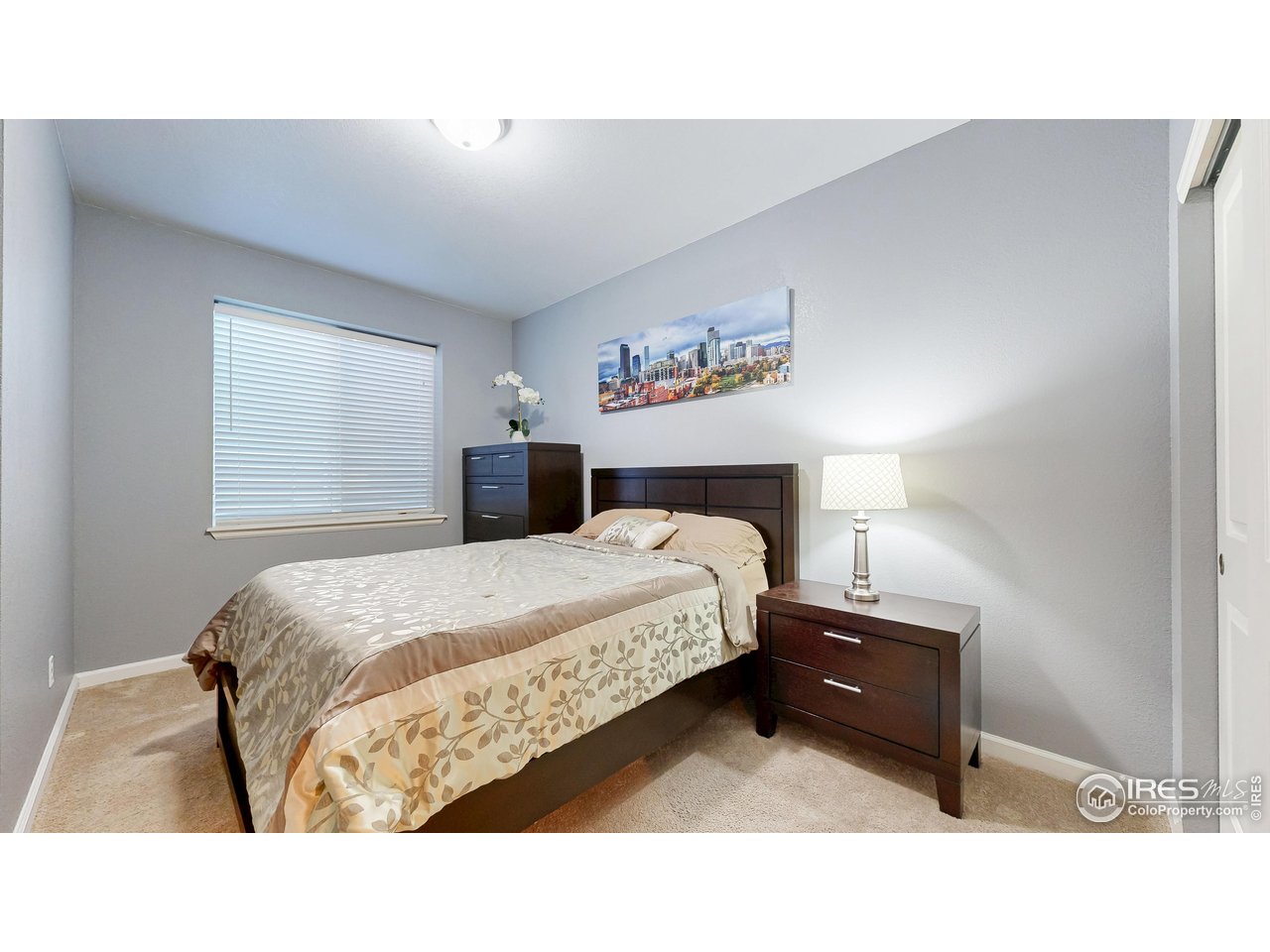 6794 Spring Rain Road Timnath, CO 80547 - Photo 35 of 49 a bedroom with a bed and a night stand