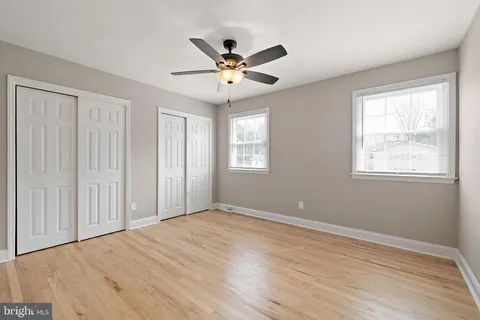 a view of a livingroom with a ceiling fan and window