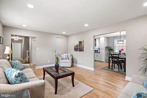 a living room with furniture a dining table and a piano table