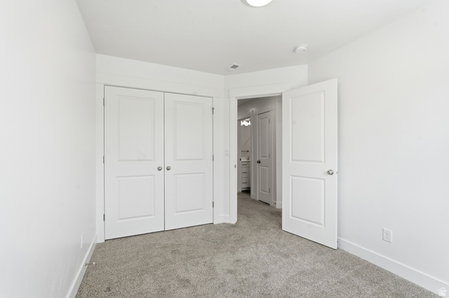 1173 West 1870 South Logan, UT 84321 - Photo 18 of 33 Bedroom featuring plush carpet flooring, bright white walls, and a recessed ceiling light