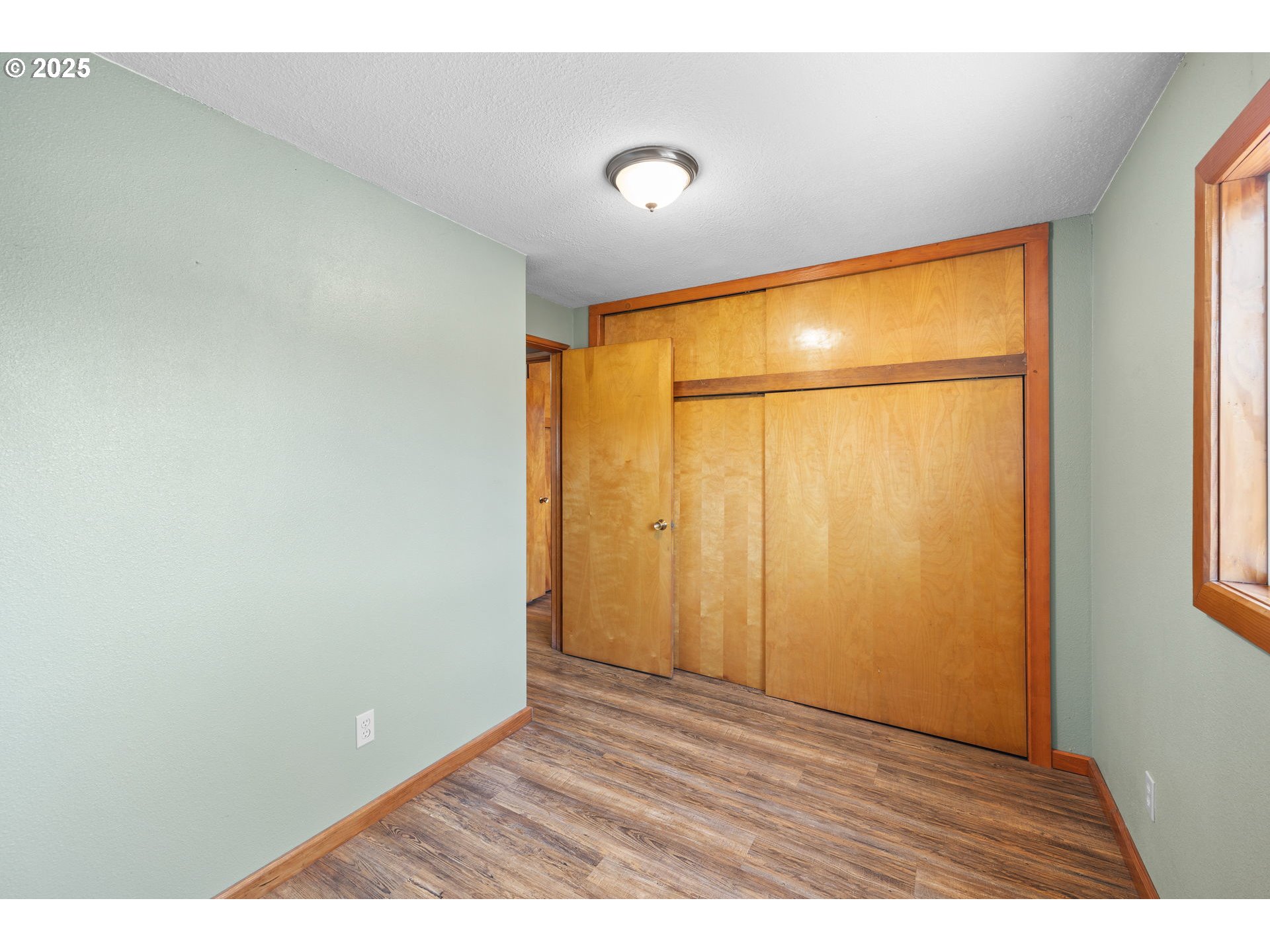 14001 South Union Mills Road Mulino, OR 97042 - Photo 11 of 48 a view of an empty room with wooden floor and a window