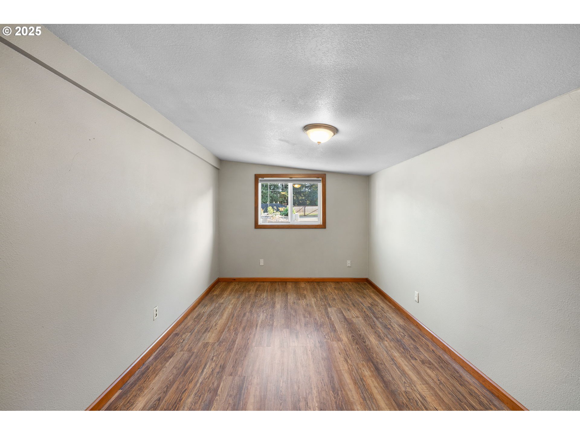 14001 South Union Mills Road Mulino, OR 97042 - Photo 15 of 48 a view of an empty room with a window and wooden floor