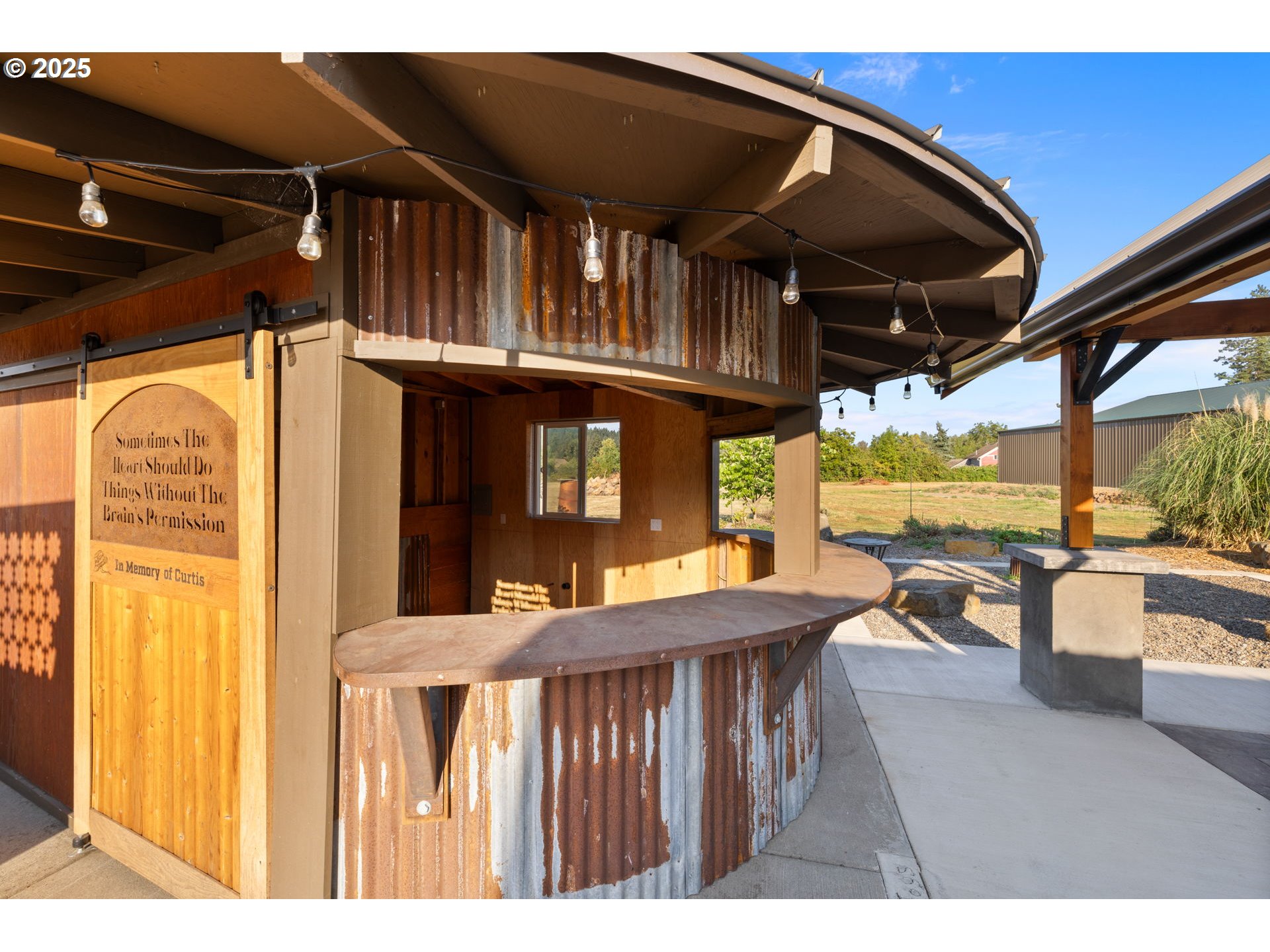 14001 South Union Mills Road Mulino, OR 97042 - Photo 39 of 48 a view of a patio with table and chairs potted plants with wooden floor