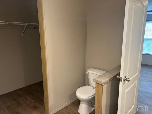 a white toilet sitting next to a shower