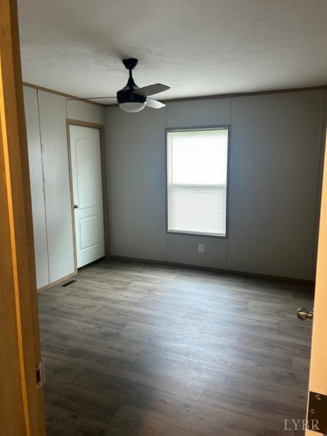 209 Lee Ford Camp Road Ridgeway, VA 24148 - Photo 14 of 19 an empty room with wooden floor cabinet and windows