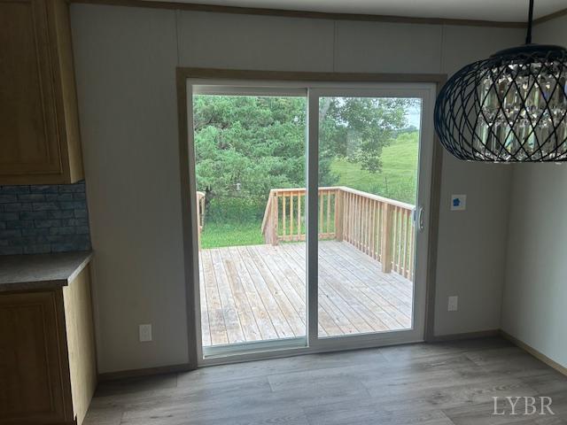 209 Lee Ford Camp Road Ridgeway, VA 24148 - Photo 6 of 19 a view of a bedroom with a bed and wooden floor