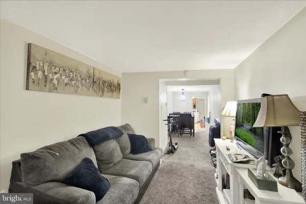 a living room with furniture and flat screen tv