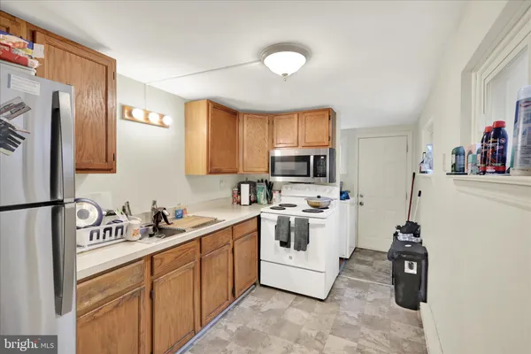 a kitchen with stainless steel appliances granite countertop a sink and cabinets