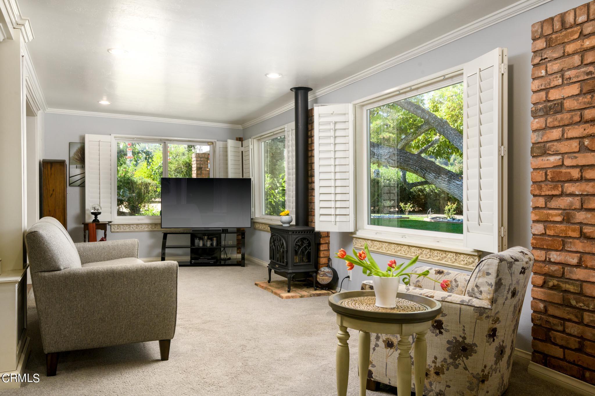 10430 Ojai Santa Paula Road Ojai, CA 93023 - Photo 9 of 25 a living room with furniture and a fireplace