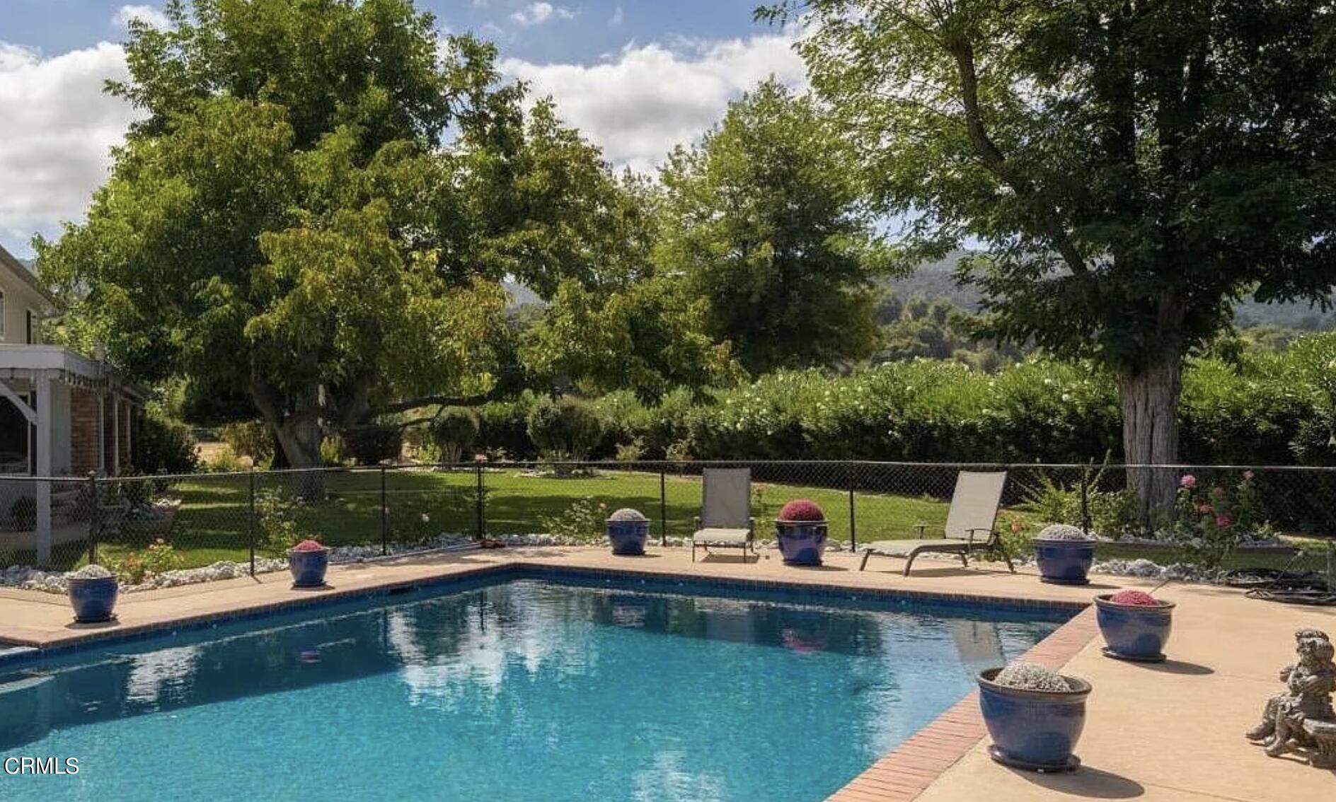 10430 Ojai Santa Paula Road Ojai, CA 93023 - Photo 17 of 25 a view of swimming pool with a table and chairs next to a yard
