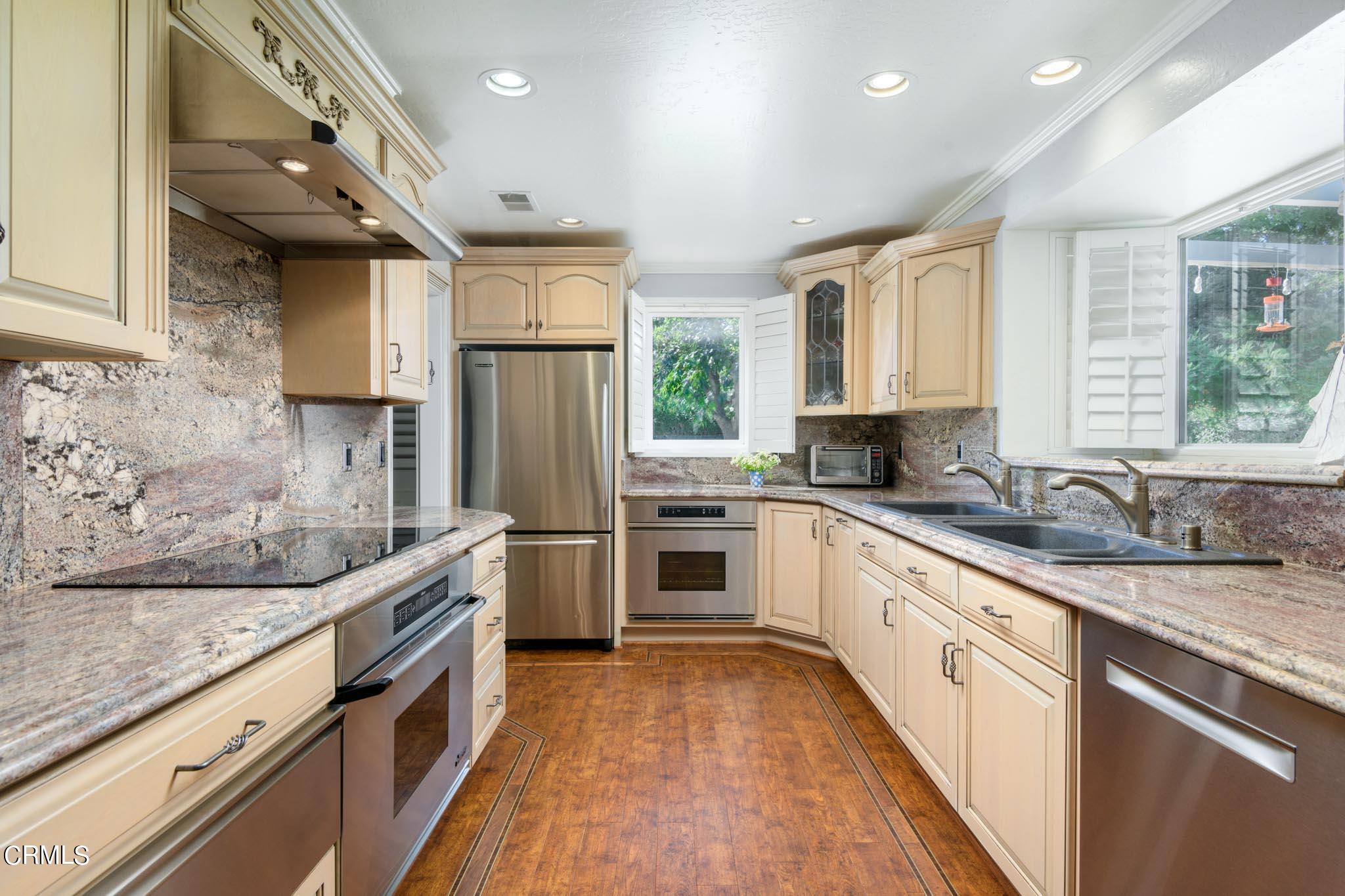 10430 Ojai Santa Paula Road Ojai, CA 93023 - Photo 7 of 25 a kitchen with stainless steel appliances granite countertop a sink stove and refrigerator