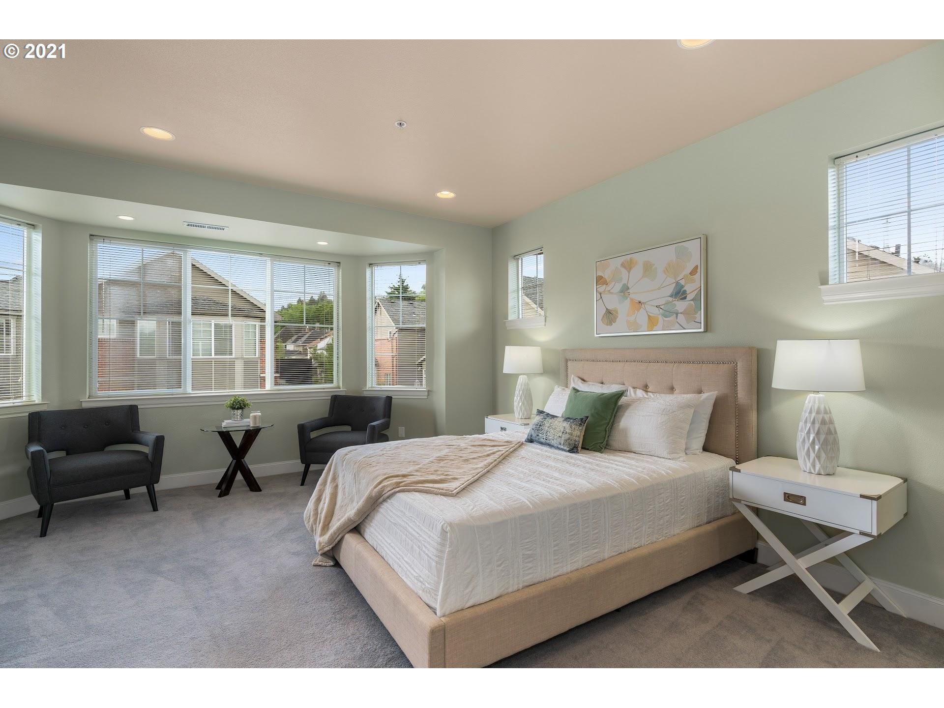 2374 Northwest Raleigh Street Portland, OR 97210 - Photo 13 of 32 a bedroom with a bed a couch and large window