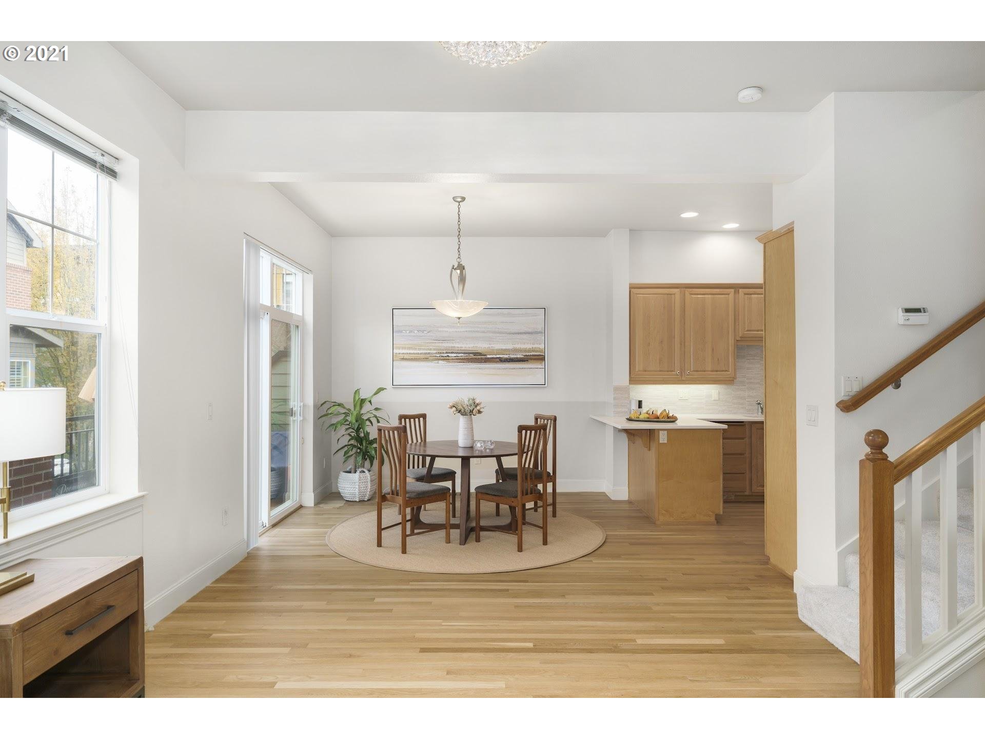 2374 Northwest Raleigh Street Portland, OR 97210 - Photo 6 of 32 a view of a dining room with furniture window and wooden floor