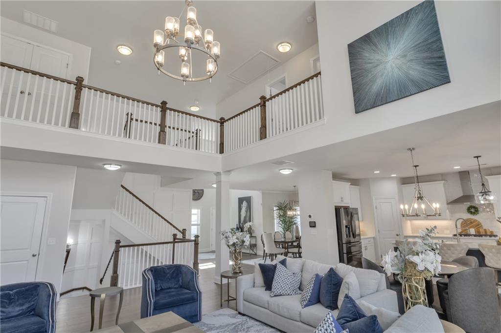 244 Wild Rose Circle Canton, GA 30115 - Photo 13 of 55 a living room with furniture a chandelier and a chandelier