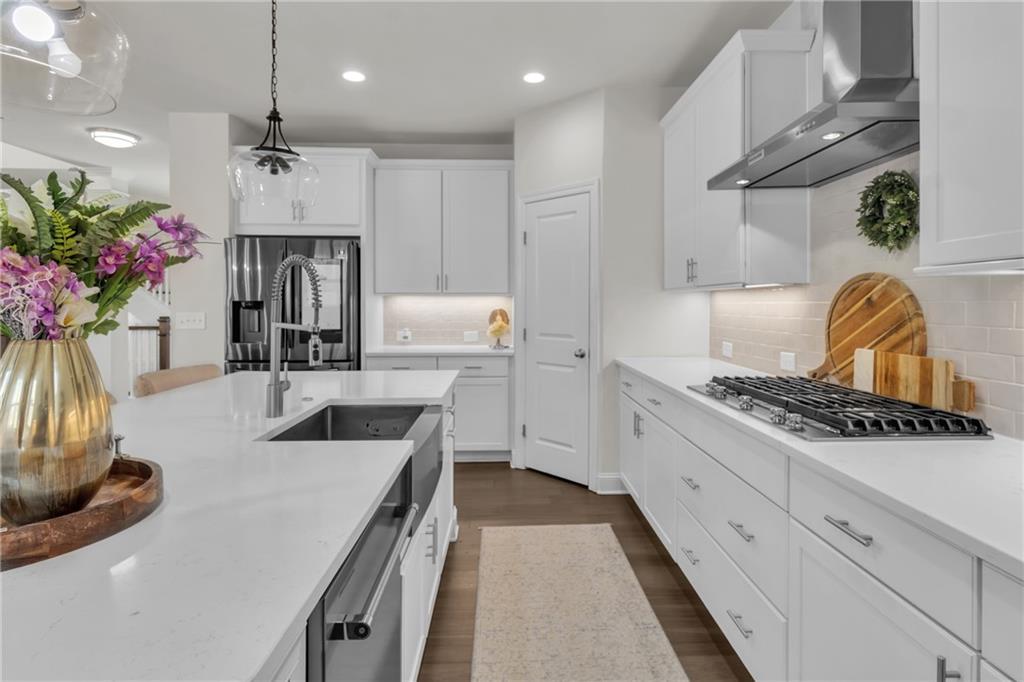 244 Wild Rose Circle Canton, GA 30115 - Photo 20 of 55 a kitchen with stainless steel appliances granite countertop a sink a stove and a refrigerator