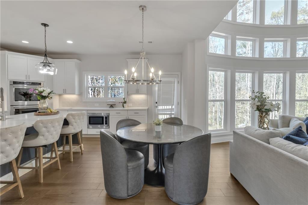 244 Wild Rose Circle Canton, GA 30115 - Photo 22 of 55 a dining room with furniture a chandelier and kitchen view