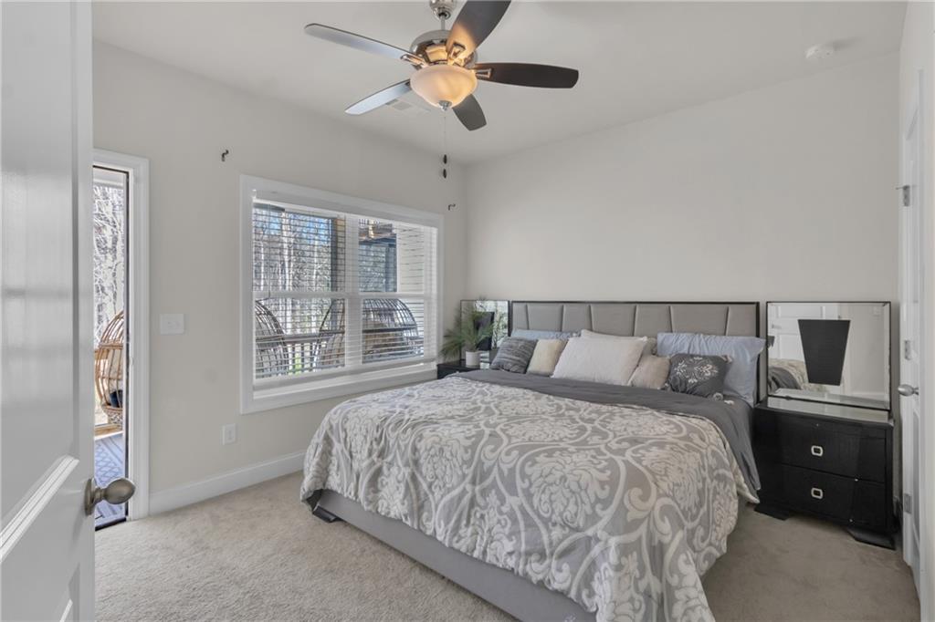 244 Wild Rose Circle Canton, GA 30115 - Photo 26 of 55 a bedroom with a large bed and a window