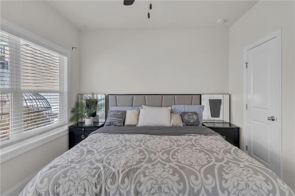 244 Wild Rose Circle Canton, GA 30115 - Photo 27 of 55 a bedroom with a large bed and a large window